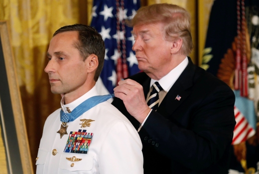 Image: U.S. President Donald Trump awards the Medal of Honor to Retired Navy Master Chief Special Warfare Operator Britt Slabinski for â€œconspicuous gallantryâ€ in the East Room of the White House in Washington